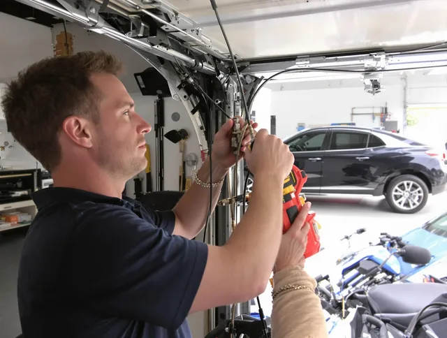 Ansonia Garage Door Repair safety certified technician performing cable replacement in Ansonia